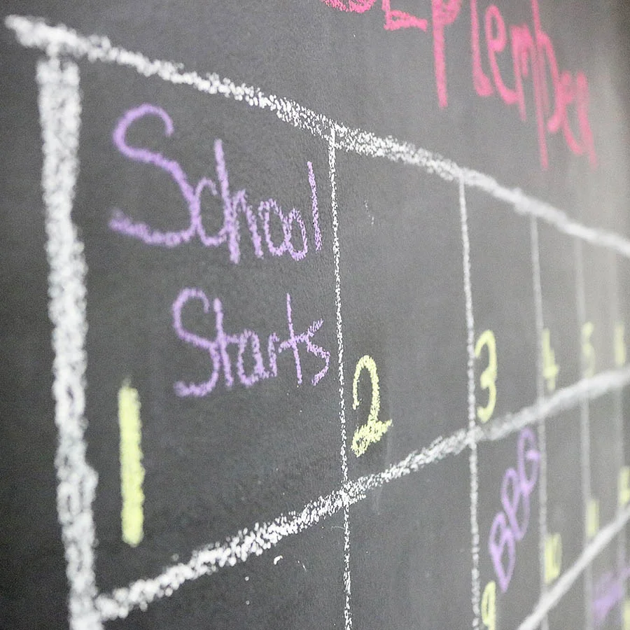 Calendar written on a chalkboard paint wall