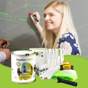 Woman draws on a grey wall coated with clear whiteboard paint kit