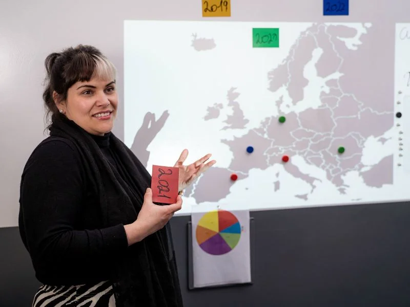 magnetic-gray-and-whiteboard-paint-wall-classroom Teacher delivering lesson with Magnetic Gray Paint and Whiteboard Paint applied to wall